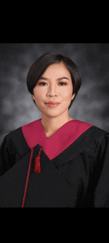 a woman in a graduation cap and gown poses for a photo