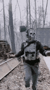 a man wearing a skull mask is walking through a forest
