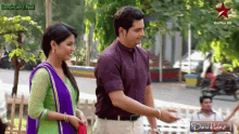 a man and a woman are standing next to each other with a desi rulez logo on the bottom