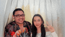 a man and a woman are posing for a picture