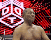 a shirtless man in a wrestling ring with a logo in the background that says dlt
