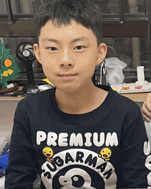 a young boy wearing a premium sugarman sweatshirt