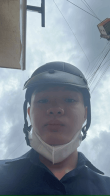 a man wearing a helmet and a mask is looking at the camera