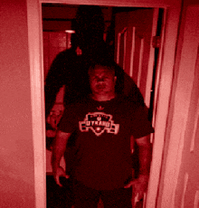 a man standing in a doorway wearing a shirt that says utah