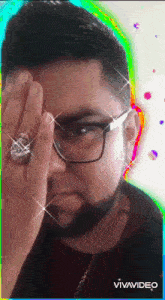 a man with glasses and a ring on his finger has a rainbow background