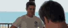 a man in a white shirt is looking at another man in a white shirt .