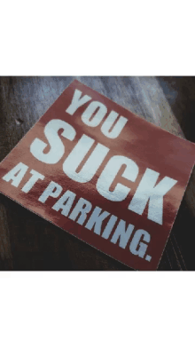 a red sticker that says you suck at parking