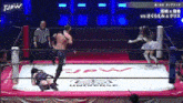 a man and a woman are wrestling in a ring with jpw written on the mat .