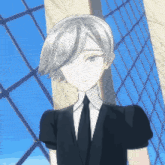 a man in a suit and tie is standing in front of a building