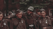 a group of soldiers are posing for a picture and one of them has a medal on his chest