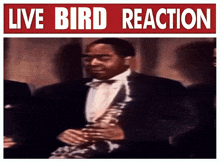 a man playing a saxophone in front of a sign that says " live bird reaction "