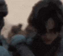 a blurry picture of a man and a woman standing next to each other in the desert .
