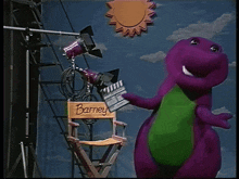 a purple dinosaur is standing next to a director 's chair with the name barney on it