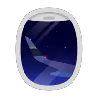 an airplane window shows the wing of a plane flying in the night sky