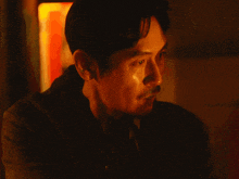 a close up of a man 's ear and neck in a dark room
