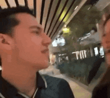 a man and a woman are kissing each other in a shopping mall .