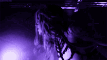 a woman is dancing in a dark room with a purple light behind her and the words hauntedmasters on the bottom