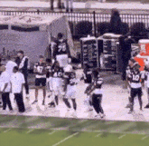a group of football players are standing on a field and one of them has the number 10 on their jersey