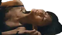 a woman in a black bra is laying down