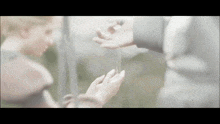 a person is holding a string in their hand and another person is holding another string in their hand .