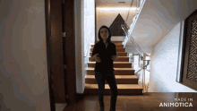 a woman is standing on a set of wooden stairs made in animatica