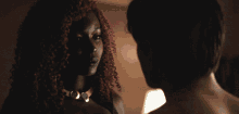 a shirtless man and a woman are dancing in a dark room