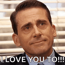 a man in a suit and tie is making a funny face and saying `` i love you to '' .