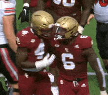 two football players are hugging each other and one has the number 9 on his jersey