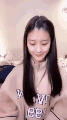a woman with long hair is wearing a sweater that says nyc ee .