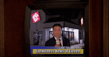 a man is jumping in the air in front of a tv that says ' breaking news ' on the screen