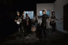 a group of women are playing guitars and singing in a room
