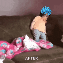 a baby is sitting on a couch with a blanket and a blue hair .