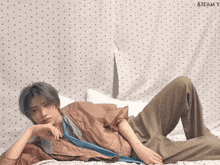 a man is laying on a bed with the words team y on the bottom right