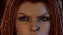 a close up of a woman 's face with red hair and a serious look on her face .