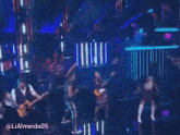 a man playing a guitar and a woman dancing on a stage with the name lialmeida05 on the bottom
