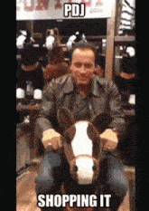 a man in a leather jacket is riding a stuffed horse in a store with the caption pdj shopping it