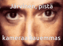 a close up of a man 's eyes with the words " jarvinen pista kameraa kauemmas " written below them
