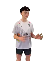a young man holding a rugby ball wearing a white shirt that says signalisation