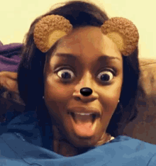 a woman is wearing a teddy bear mask and making a funny face .