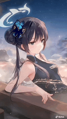 a girl with a blue butterfly in her hair is sitting in a bathtub .