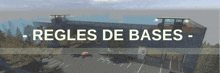 a sign that says ' regels de bases ' on it in front of a building