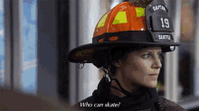 a woman wearing a firefighter 's helmet says who can skate