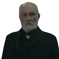 a man with a beard and mustache wearing a black suit and bow tie