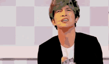 a man in a black jacket is making a face