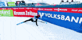 a person is skiing in front of a banner that says volksbank on it