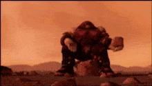 a robot is sitting on top of a rock in a desert .