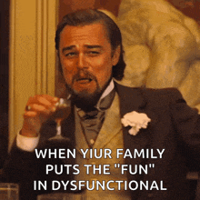 a man in a suit and tie holds a glass of wine and says when your family puts the " fun " in dysfunctional