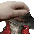 a hand is putting a hat on a statue .