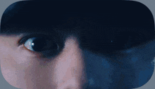 a close up of a person 's eye with a black background