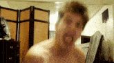 a man without a shirt is making a funny face with his tongue out